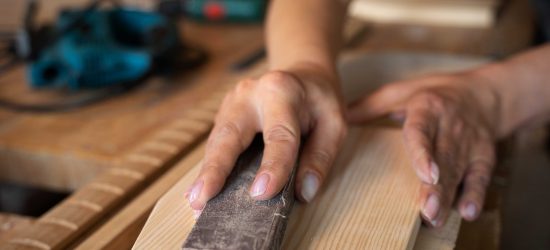 high-angle-woman-measuring-wood