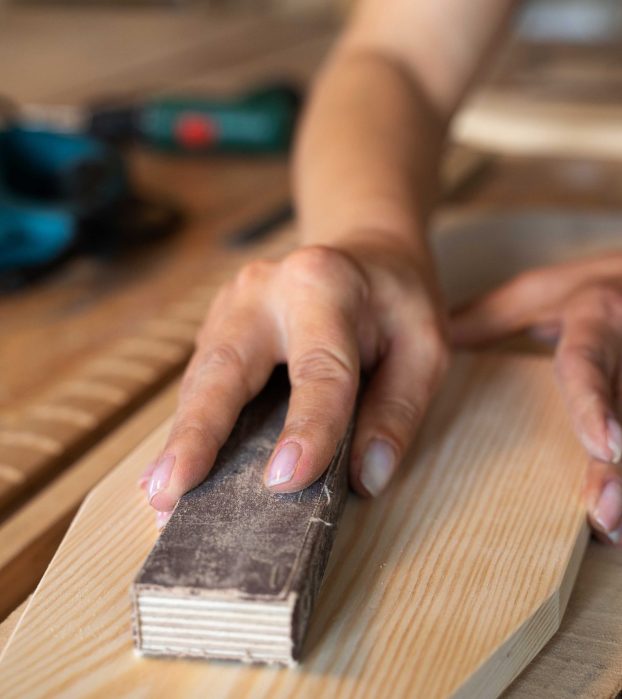 high-angle-woman-measuring-wood